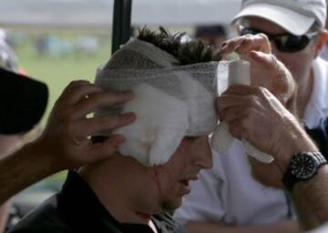 A spectator is assisted by medical staff after getting hit in the head by a drive from Jose Maria Olazabal of Spain on the eighth hole during a practice round in preparation for the 2013 Masters golf tournament at the Augusta National Golf Club in Augusta, Georgia, April 8, 2013. REUTERS/Mark Blinch (UNITED STATES - Tags: SPORT GOLF)