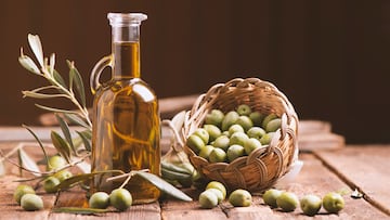Olive oil and olives on wooden rustic table