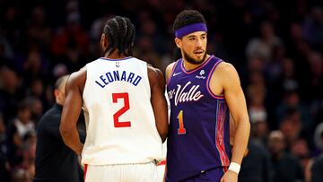 Jan 3, 2024; Phoenix, Arizona, USA; LA Clippers forward Kawhi Leonard (2) and Phoenix Suns guard Devin Booker (1) run into each during the second quarter at Footprint Center. Mandatory Credit: Mark J. Rebilas-USA TODAY Sports