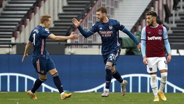 LONDON, ENGLAND - MARCH 21: Calum Chambers of Arsenal celebrates his side's second goal with Martin Odegaard during the Premier League match between West Ham United and Arsenal at London Stadium on March 21, 2021 in London, England. Sporting stadiums