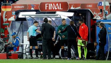 Referee Milorad Mazic consults with the VAR before showing Chile’s Gonzalo Jara a yellow card.