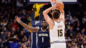Nov 6, 2023; Denver, Colorado, USA; Denver Nuggets center Nikola Jokic (15) attempts a shot as New Orleans Pelicans forward Zion Williamson (1) guards in the first quarter at Ball Arena. Mandatory Credit: Isaiah J. Downing-USA TODAY Sports