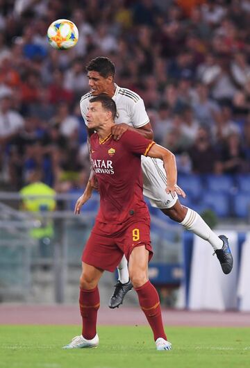 Edin Dzeko y Raphael Varane.