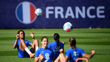 France's defender Wendie Renard (L) plays the ball during a training session at the team's base camp in Ashby-de-la-Zouch in central England, on July 5, 2022, during the UEFA Euro 2022 football tournament. (Photo by FRANCK FIFE / AFP)