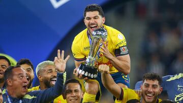 America's forward #21 Henry Martin lifts the trophy after the Liga MX Apertura tournament final second-leg football match between Monterrey and America at the BBVA Stadium in Monterrey, Nuevo Leon State, Mexico on December 15, 2024. (Photo by Julio Cesar AGUILAR / AFP)