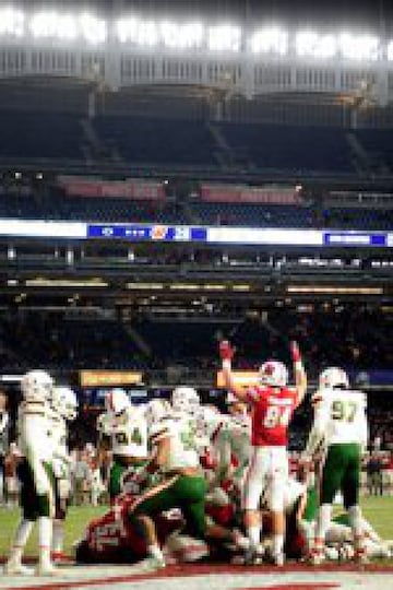 NEW YORK, NEW YORK - DECEMBER 27: Jake Ferguson #84 of the Wisconsin Badgers raises his arms in the air after the Badgers score a touchdown in the final minutes of the fourth quarter at the New Era Pinstripe Bowl against the Miami Hurricanes at Yankee Stadium on December 27, 2018 in the Bronx borough of New York City.