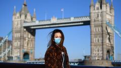 ***BESTPIX*** LONDON, ENGLAND - MARCH 22:  A member of the public poses for a photo in front of Tower Bridge whilst wearing a protective mask on March 22, 2020 in London, England. Coronavirus (COVID-19) has spread to at least 188 countries, claiming over 