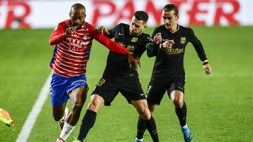 Granada&#039;s Ramon Azeez, left, fights for the ball with Barcelona&#039;s Jordi Alba, center, and Barcelona&#039;s Antoine Griezmann during the Spanish La Liga soccer match between Granada and FC Barcelona at the Los Carmenes stadium in Granada, Spain, 