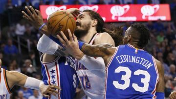 Oklahoma City Thunder center Steven Adams (12) is fouled by Philadelphia 76ers forward Robert Covington (33) during the third quarter of an NBA basketball game in Oklahoma City, Wednesday, March 22, 2017. Oklahoma City won 122-97. (AP Photo/Sue Ogrocki)