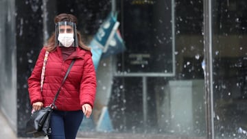 A woman wearing a face mask as a protective measure against the coronavirus disease (COVID-19) walks past a closed currency exchange shop, in downtown Buenos Aires, Argentina May 22, 2020. REUTERS/Agustin Marcarian