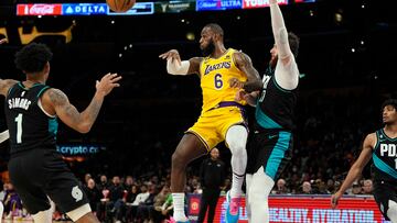 LOS ANGELES, CA - NOVEMBER 30: LeBron James #6 of the Los Angeles Lakers makes a no-look pass to teammate Austin Reaves (not pictured), who scored a three-point basket, as James is guarded by Jusuf Nurkic #27 of the Portland Trail Blazers in the second half at Crypto.com Arena on November 30, 2022 in Los Angeles, California. NOTE TO USER: User expressly acknowledges and agrees that, by downloading and or using this photograph, User is consenting to the terms and conditions of the Getty Images License Agreement. Kevork Djansezian/Getty Images/AFP (Photo by KEVORK DJANSEZIAN / GETTY IMAGES NORTH AMERICA / Getty Images via AFP)