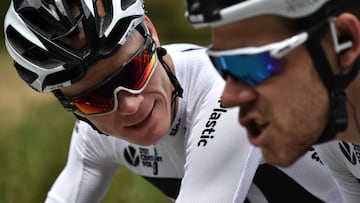 Great Britain's Christopher Froome (L) and his Great Britain's Team Sky cycling team teammate, Great Britain's Luke Rowe talk during the 13th stage of the 105th edition of the Tour de France cycling race, between Le Bourg-d'Oisans and Valence, on July 20, 2018. / AFP PHOTO / Marco BERTORELLO