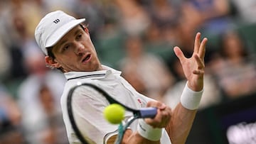 Chile's Nicolas Jarry plays a forehand return to Britain's Cameron Norrie during their men's singles fourth round tennis match on the seventh day of the 2025 Wimbledon Championships at The All England Lawn Tennis and Croquet Club in Wimbledon, southwest London, on July 6, 2025. (Photo by Glyn KIRK / AFP) / RESTRICTED TO EDITORIAL USE