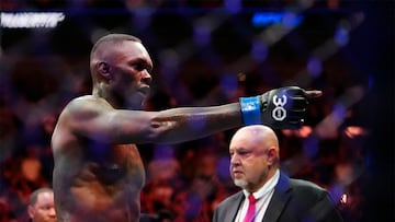 Apr 8, 2023; Miami, Florida, USA; Israel Adesanya (blue gloves) reacts to defeating Alex Pereira (red gloves) during UFC 287 at Miami-Dade Arena. Mandatory Credit: Rich Storry-USA TODAY Sports