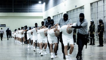 Salvadoran police officers escort alleged members of the Venezuelan gang Tren de Aragua recently deported by the U.S. government to be imprisoned in the Terrorism Confinement Center (CECOT) prison, as part of an agreement with the Salvadoran government, in Tecoluca, El Salvador, in this handout image obtained March 16, 2025. Secretaria de Prensa de la Presidencia/Handout via REUTERS ATTENTION EDITORS - THIS IMAGE HAS BEEN SUPPLIED BY A THIRD PARTY. NO RESALES. NO ARCHIVES