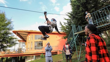 A Kenyan tourist descends on the longest zip line in East Africa with a length of 2.2 kilometres at 'The Forest' inside Kereita forest during a subsidized tour trip organized by a local tour company in Kimende, Kiambu.
