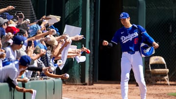 Mar 3, 2024; Phoenix, Arizona, USA; Los Angeles Dodgers designated hitter Shohei Ohtani signs autographs prior to game against the Colorado Rockies during spring training at Camelback Ranch-Glendale. Mandatory Credit: Mark J. Rebilas-USA TODAY Sports TPX IMAGES OF THE DAY