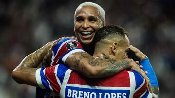 Fortaleza's forward #18 Deyverson (L) celebrates with teammate forward #26 Breno Lopes after scoring a goal during the Copa Libertadores group stage first round football match between Brazil's Fortaleza and Chile's Colo Colo at the Arena Castelao stadium in Fortaleza, Brazil, on May 6, 2025. (Photo by Thiago GADELHA / AFP)