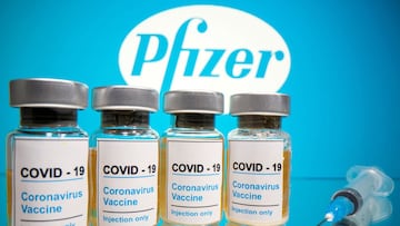 FILE PHOTO: Vials with a sticker reading, &quot;COVID-19 / Coronavirus vaccine / Injection only&quot; and a medical syringe are seen in front of a displayed Pfizer logo in this illustration taken October 31, 2020. REUTERS/Dado Ruvic/Illustration/File Phot