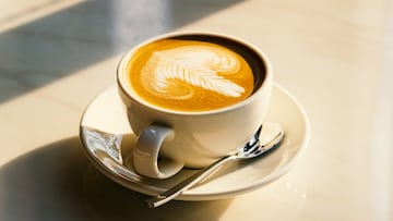 Feshly brewed latte coffee on a white table, a coffee drink made with espresso and steamed milk.