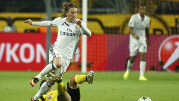 Dortmund&#039;s midfielder Raphael Guerreiro fouls Real Madrid&#039;s Croatian midfielder Luka Modric during the UEFA Champions League.