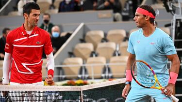 Spain's Rafael Nadal (R) and Serbia's Novak Djokovic talk prior to their men's final tennis match at the Philippe Chatrier court on Day 15 of The Roland Garros 2020 French Open tennis tournament in Paris on October 11, 2020. (Photo by Anne-Christine POUJO