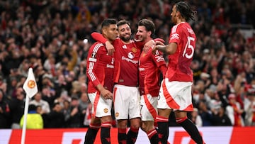 Manchester United's Brazilian midfielder #18 Casemiro (L) celebrates with teammates after scoring Manchester United's second goal during the UEFA Europa League semi final second leg football match between Manchester United and Athletic Club Bilbao at Old Trafford stadium in Manchester, north west England, on May 8, 2025. (Photo by Oli SCARFF / AFP)