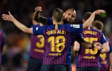 Barcelona's Spanish defender Jordi Alba celebrates scoring his team's second goal with Barcelona's Chilean midfielder Arturo Vidal