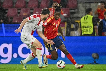 Spain's midfielder #17 Nico Williams runs with the ball past Georgia's defender #02 Otar Kakabadze during the UEFA Euro 2024 round of 16 football match between Spain and Georgia at the Cologne Stadium in Cologne on June 30, 2024. (Photo by Alberto PIZZOLI / AFP)