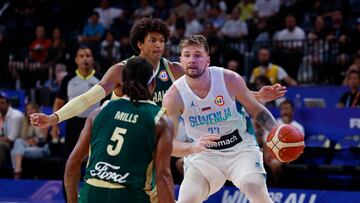 Basketball - FIBA World Cup 2023 - Second Round - Group K - Slovenia v Australia - Okinawa Arena, Okinawa, Japan - September 1, 2023 Slovenia's Luka Doncic in action with Australia's Matisse Thybulle and Patty Mills REUTERS/Issei Kato