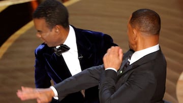 FILE PHOTO: Will Smith (R) hits Chris Rock as Rock spoke on stage during the 94th Academy Awards in Hollywood, Los Angeles, California, U.S., March 27, 2022. REUTERS/Brian Snyder/File Photo