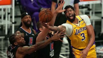 May 6, 2021; Los Angeles, California, USA; Los Angeles Lakers forward Anthony Davis (3) is defended by LA Clippers forward Kawhi Leonard (2) and center Ivica Zubac (40) in the first half at Staples Center. Mandatory Credit: Kirby Lee-USA TODAY Sports