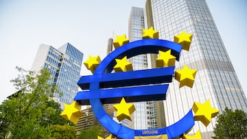 Close view of The Euro-Skulptur with multiple skyscrapers on the background in Frankfurt downtown, Germany. Flag of Ukraine and blood on it