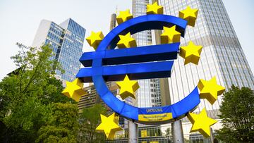 Close view of The Euro-Skulptur with multiple skyscrapers on the background in Frankfurt downtown, Germany. Flag of Ukraine and blood on it