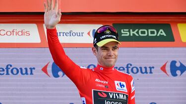 Overall ranking leader Team Visma's Wout van Aert celebrates on the podium retaining the red jersey after winning the stage 3 of La Vuelta a Espana cycling tour, a 191.2 km race between Lousa and Castelo Branco, on August 19, 2024. (Photo by MIGUEL RIOPA / AFP)