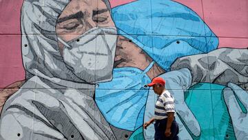 A man walks past a coronavirus-related mural, in Acapulco, Guerrero state, Mexico, on May 1, 2020. (Photo by FRANCISCO ROBLES / AFP)