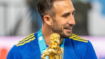 Argentina's Boca Juniors Marcelo Weigandt holds the winners trophy following a friendly football match between Spain's Barcelona and Argentina's Boca Juniors part of the Maradona Cup at the Mrsool Park Stadium in the Saudi capital Riyadh on December 14, 2021. (Photo by AFP)