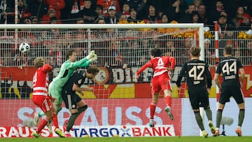 Union Berlin's Danish goalkeeper #01 Frederik Ronnow (2L) fails to save the ball as Union Berlin's Portuguese defender #04 Diogo Leite (3R) heads the ball to score an own goal during the German Cup (DFB-Pokal) round of 16 football match between 1 FC Union Berlin and FC Bayern Munich in Berlin on December 3, 2025. (Photo by Odd ANDERSEN / AFP) / DFB REGULATIONS PROHIBIT ANY USE OF PHOTOGRAPHS AS IMAGE SEQUENCES AND QUASI-VIDEO.