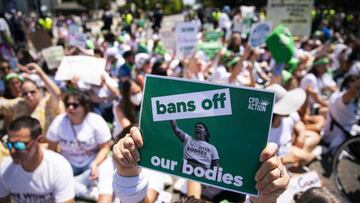 An abortion rights demonstrator holds a "bans off our bodies" sign while blocking an intersection during a protest near the US Supreme Court in Washington, D.C., US, on Thursday, June 30, 2022. President Biden today said he would support changing the Senate's filibuster rules to pass legislation ensuring privacy rights and access to abortion, calling the Supreme Court "destabilizing" for controversial decisions, including overturning Roe v. Wade. Photographer: Al Drago/Bloomberg via Getty Images