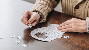 cropped view of senior man playing with puzzles