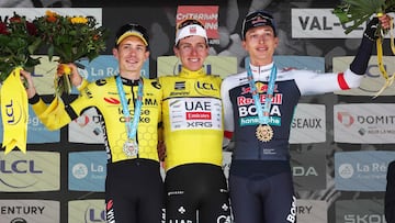 Second placed for the overall race Team Visma - Lease a Bike's Danish rider Jonas Vingegaard (L), first placed UAE Team Emirates XRG's Slovenian rider Tadej Poga?ar wearing the overall leader's yellow jersey and third placed Red Bull - BORA - hansgrohe's German rider Florian Lipowitz celebrate on the podium of the 8th and final stage of the 77th edition of the Criterium du Dauphine cycling race, 133,3 km between Val-d'Arc and Val-Cenis - Plateau du Mont Cenis, on June 15, 2025. (Photo by Anne-Christine POUJOULAT / AFP)