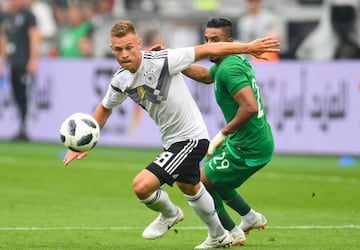 Germany's midfielder Joshua Kimmich (L) and Saudi Arabia's midfielder Salem Al-Dawsari