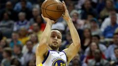 (FILES) In this file photo taken on February 25, 2019, Stephen Curry of the Golden State Warriors shoots during their game against the Charlotte Hornets at Spectrum Center in Charlotte, North Carolina. - Curry said on April 3, 2019, that a decision to start wearing contact lenses has helped him reverse a dip in his shooting numbers. Curry told The Athletic in an interview he had started wearing contact lenses to offset problems caused by a condition of the cornea called Keratoconus. (Photo by STREETER LECKA / GETTY IMAGES NORTH AMERICA / AFP)