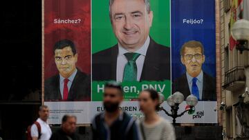 Spain's Socialist Party leader and Prime Minister Pedro Sanchez and opposition People's Party leader Alberto Nunez Feijoo are pictured alongside Basque Nationalist Party (PNV) candidate Aitor Esteban on a poster reading, 'Sanchez?, Feijoo? Here, PNV.' in Bilbao, Spain, July 24, 2023. REUTERS/Vincent West