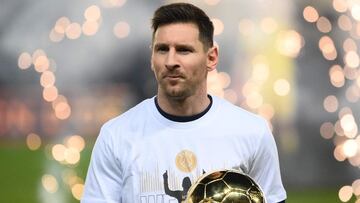 Paris Saint-Germain's Argentinian forward Lionel Messi presents his men's Ballon d'Or award prior to the French L1 football match between Paris-Saint Germain (PSG) and OGC Nice at The Parc des Princes Stadium in Paris on December 1, 2021. (
