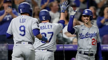 DENVER, COLORADO - SEPTEMBER 22: Luke Raley #37 of the Los Angeles Dodgers is congratulated as he enters the dugout by Walker Buehler #21 after hitting a 2 RBI home run against the Colorado Rockies in the fourth inning at Coors Field on September 22, 2021