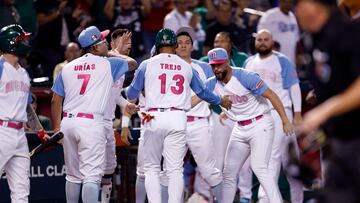 PHOENIX, ARIZONA - MARCH 14: Alan Trejo #13 of Team Mexico celebrates with teammates after scoring against Team Great Britain during the seventh inning of the World Baseball Classic Pool C game at Chase Field on March 14, 2023 in Phoenix, Arizona.   Chris Coduto/Getty Images/AFP (Photo by Chris Coduto / GETTY IMAGES NORTH AMERICA / Getty Images via AFP)