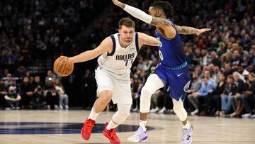 Mar 25, 2022; Minneapolis, Minnesota, USA; Dallas Mavericks guard Luka Doncic (77) drives to the basket while Minnesota Timberwolves guard D'Angelo Russell (0) defends in the first quarter at Target Center. Mandatory Credit: David Berding-USA TODAY Sports