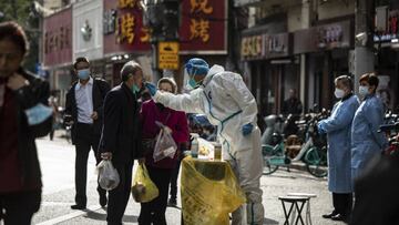 A healthcare worker in personal protective equipment (PPE) collects swab sample from a resident for a Covid-19 test in Shanghai, China, on Sunday, Nov. 6, 2022. China will unswervingly adhere to its current Covid controls as the country faces increasingly serious outbreaks, health officials said, damping hopes that Beijing will ease its stringent policies that have put cities and factories under prolonged lockdowns. Photographer: Qilai Shen/Bloomberg via Getty Images