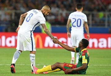 Chile's midfielder Arturo Vidal (L) helps Cameroon's forward Benjamin Moukandjo stand up after a fall during the 2017 Confederations Cup group B football match between Cameroon and Chile at the Spartak Stadium in Moscow on June 18, 2017. / AFP PHOTO / Yuri KADOBNOV